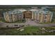 Aerial view of condominium building with golf course and palm trees at 4650 Links Village Dr # B103, Ponce Inlet, FL 32127