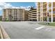 Exterior view of a residential building with a parking garage and well-maintained landscaping at 4650 Links Village Dr # B103, Ponce Inlet, FL 32127