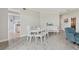 Bright dining room with a white table, chairs, and sideboard, offering an elegant space for meals and gatherings at 4650 Links Village Dr # B103, Ponce Inlet, FL 32127