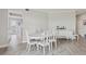 Bright dining room with a white table, chairs, and sideboard, offering an elegant space for meals and gatherings at 4650 Links Village Dr # B103, Ponce Inlet, FL 32127