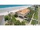 Gorgeous beachfront property featuring a tan exterior, covered parking and manicured landscaping at 4650 Links Village Dr # B103, Ponce Inlet, FL 32127