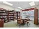 A view of the game room with bookshelves and a round table with chairs at 4650 Links Village Dr # B103, Ponce Inlet, FL 32127