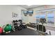 Bright gym featuring modern exercise equipment, large mirrors, and ocean views at 4650 Links Village Dr # B103, Ponce Inlet, FL 32127