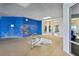An indoor hot tub room features a blue mural, bright lighting, and natural views for a relaxing atmosphere at 4650 Links Village Dr # B103, Ponce Inlet, FL 32127