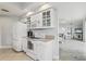 Bright kitchen with white cabinets, a microwave, appliances, and a view of living room and bedrooms at 4650 Links Village Dr # B103, Ponce Inlet, FL 32127