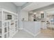 Modern kitchen with white cabinets, stainless steel appliances, bar seating, and tile flooring at 4650 Links Village Dr # B103, Ponce Inlet, FL 32127