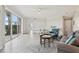 Bright and airy living room with sliding glass doors and wood-look tile flooring at 4650 Links Village Dr # B103, Ponce Inlet, FL 32127