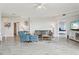 Spacious living room with ceiling fan, wood-look flooring, comfortable seating, and access to the bedrooms at 4650 Links Village Dr # B103, Ponce Inlet, FL 32127
