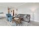 Comfortable living room featuring a plush gray sofa, an accent chair, and stylish decor, creating an inviting atmosphere at 4650 Links Village Dr # B103, Ponce Inlet, FL 32127