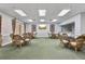 A view of the lounge area with multiple seating arrangements and a TV at 4650 Links Village Dr # B103, Ponce Inlet, FL 32127