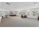 Spacious lounge with comfortable seating, a ping pong table, and ample natural light at 4650 Links Village Dr # B103, Ponce Inlet, FL 32127
