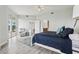 Spacious main bedroom with a blue quilt, private deck access, and en-suite bathroom, designed for relaxation at 4650 Links Village Dr # B103, Ponce Inlet, FL 32127