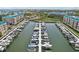 Scenic marina view with multiple boats docked and waterfront condos in the background at 4650 Links Village Dr # B103, Ponce Inlet, FL 32127
