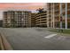Condominium parking garage with a multi-level parking structure and palm trees at 4650 Links Village Dr # B103, Ponce Inlet, FL 32127