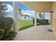 Covered patio overlooking a lush green lawn and palm trees at 4650 Links Village Dr # B103, Ponce Inlet, FL 32127