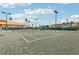 Well-maintained tennis court on a sunny day with surrounding landscaping at 4650 Links Village Dr # B103, Ponce Inlet, FL 32127