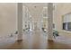 Picturesque walkway with stone floor and white columns with plants and trees at 4650 Links Village Dr # B103, Ponce Inlet, FL 32127