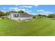 Wide-open backyard with lush green grass, a screened-in porch, and a patio area, ideal for relaxing and enjoying the outdoors at 5305 Ingleside, Leesburg, FL 34748