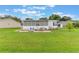 Spacious backyard with patio, seating area, and a well-maintained lawn, perfect for outdoor entertaining at 5305 Ingleside, Leesburg, FL 34748