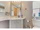 Bathroom features a single sink vanity with white countertop, a large mirror, and a toilet next to a window at 5305 Ingleside, Leesburg, FL 34748