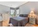 Serene bedroom featuring soft lighting, laminate wood flooring, dresser, and neutral decor at 5305 Ingleside, Leesburg, FL 34748