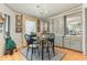 Cozy dining area with a glass-top table, chandelier, and charming built-in cabinets with a view into the kitchen at 5305 Ingleside, Leesburg, FL 34748