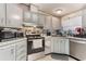 Kitchen featuring light gray cabinetry, stainless steel appliances, and a modern sink with matte black faucet at 5305 Ingleside, Leesburg, FL 34748