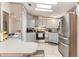Well-lit kitchen with modern stainless steel appliances, ample counter space, and stylish backsplash at 5305 Ingleside, Leesburg, FL 34748