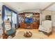 Comfortable living room featuring a large entertainment center, hardwood floors, and cozy furniture at 5305 Ingleside, Leesburg, FL 34748