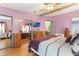 Spacious bedroom featuring an en suite bathroom, closet with mirrored doors, and laminate wood flooring at 5305 Ingleside, Leesburg, FL 34748