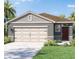 Charming single-story home with a neutral color scheme and well-manicured landscaping at 5718 Somerset Dr, Haines City, FL 33844