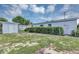 Exterior of a backyard featuring a white detached shed and grassy area at 603 Carver Dr, Lake Wales, FL 33853