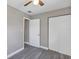 Bright bedroom with a ceiling fan and double door closet for ample storage at 603 Carver Dr, Lake Wales, FL 33853