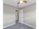 Bedroom featuring neutral walls, gray floors, and a view to another room at 603 Carver Dr, Lake Wales, FL 33853