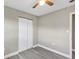 Bedroom featuring neutral walls, gray floors, and a closet with double doors at 603 Carver Dr, Lake Wales, FL 33853