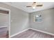 Bedroom featuring neutral walls, gray floors, and a window at 603 Carver Dr, Lake Wales, FL 33853