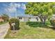 Charming single-story home surrounded by mature trees and lush green lawn at 603 Carver Dr, Lake Wales, FL 33853