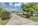 Charming single-story home featuring a well-maintained lawn and a cracked concrete driveway at 603 Carver Dr, Lake Wales, FL 33853