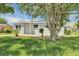 Well-maintained single-story home with a manicured lawn and mature trees at 603 Carver Dr, Lake Wales, FL 33853