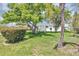 Charming single-story home showcasing a well-manicured lawn and mature trees at 603 Carver Dr, Lake Wales, FL 33853