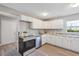 A bright kitchen features new stainless steel appliances, white cabinets, and modern countertops at 603 Carver Dr, Lake Wales, FL 33853