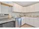Modern kitchen showcasing white cabinets, marble countertops, and stainless steel appliances at 603 Carver Dr, Lake Wales, FL 33853