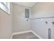 A spacious, neutral utility room features modern gray flooring and neutral colored walls at 603 Carver Dr, Lake Wales, FL 33853