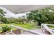 Expansive backyard view from deck, featuring lush greenery, mature trees and brick patio for outdoor enjoyment at 625 Woodlawn Cemetery Rd, Gotha, FL 34734