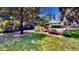 Lush backyard with a seating area, garden swing, and covered patio for outdoor entertainment at 625 Woodlawn Cemetery Rd, Gotha, FL 34734