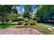 Charming backyard featuring a patio, outdoor dining set, and lush landscaping for relaxing outdoor living at 625 Woodlawn Cemetery Rd, Gotha, FL 34734
