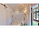 Modern bathroom with a glass-enclosed shower and vintage-style fixtures and stained-glass window at 625 Woodlawn Cemetery Rd, Gotha, FL 34734