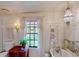 Bright bathroom featuring a tub, vanity and sink, window, and classic decor at 625 Woodlawn Cemetery Rd, Gotha, FL 34734