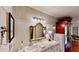 Bathroom features beadboard walls, and an ornate mirror above the vanity at 625 Woodlawn Cemetery Rd, Gotha, FL 34734