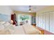 Bright bedroom features a ceiling fan, closet, and a door leading to the outdoor deck at 625 Woodlawn Cemetery Rd, Gotha, FL 34734